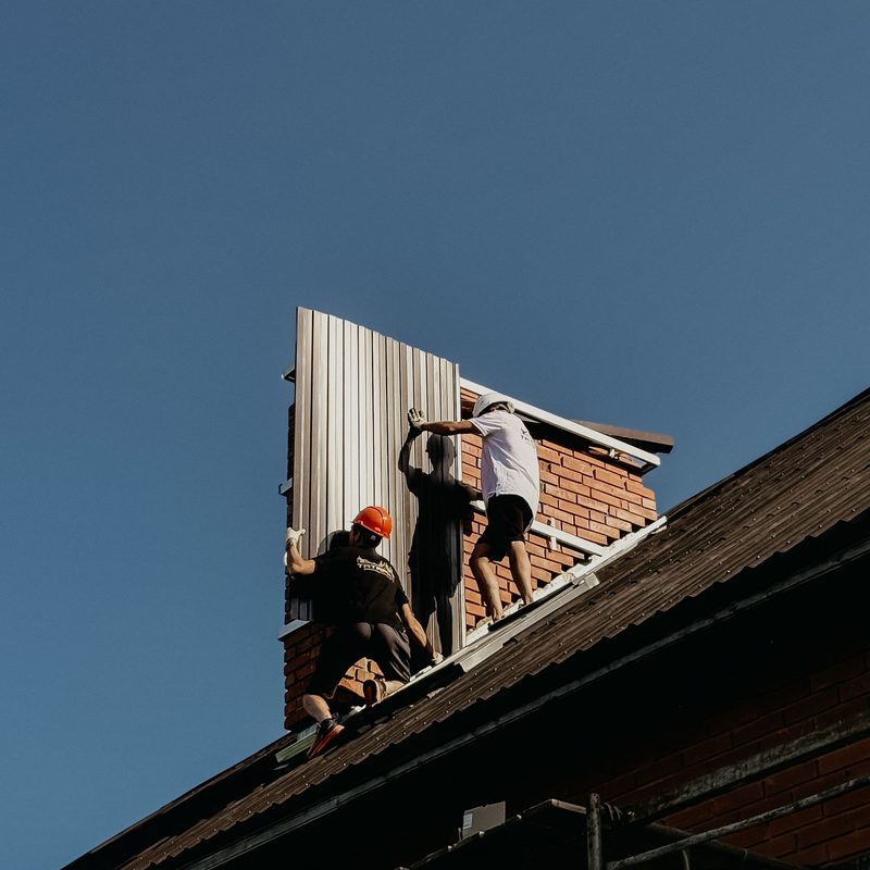 Metal roof panels being installed